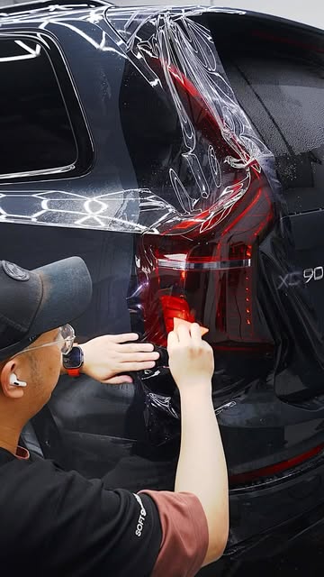 Clear film being worked around the rear bodywork of a Volvo at G’ZOX Adelaide