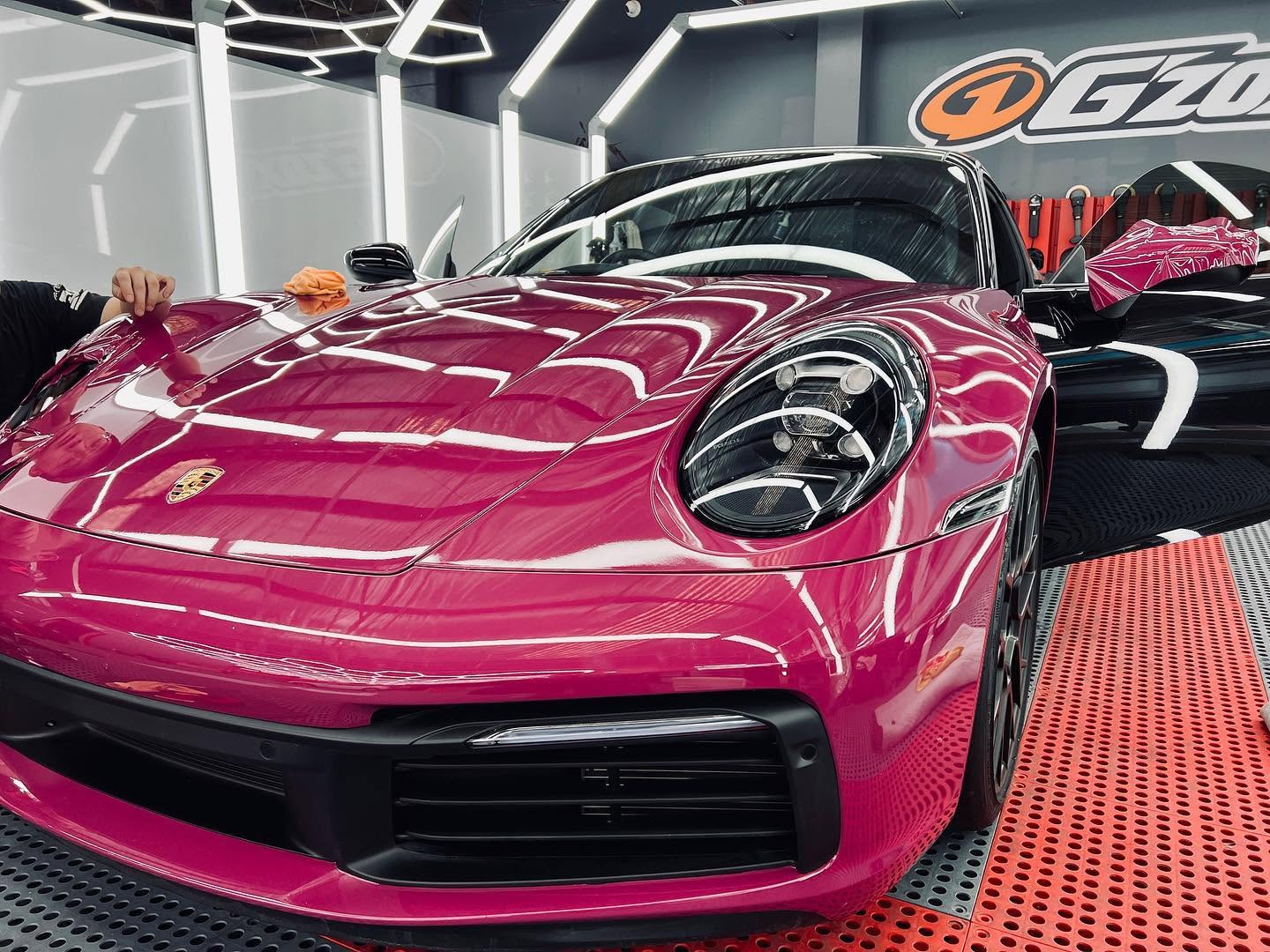 Colour wrap being fitted around the mirror of a Porsche without removing the mirror